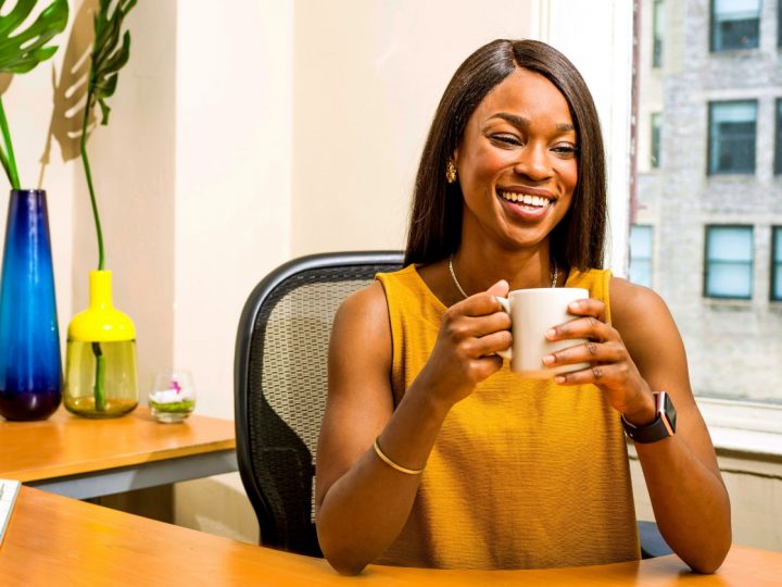 Woman Drinking Coffee at Work Desk